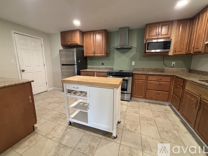 A kitchen with a white island in the middle of the room.
