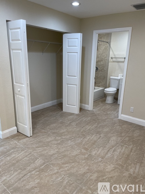 A bathroom with a toilet and a walk-in shower.