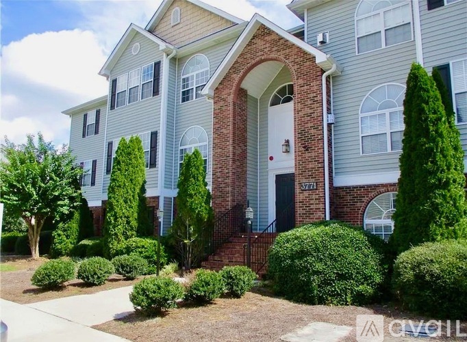 A brick house with a white door and windows.