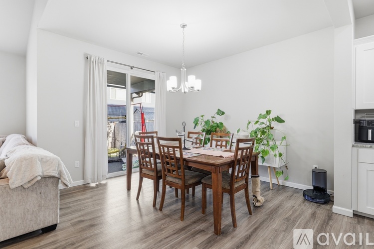 A dining room with a wooden table and chairs.