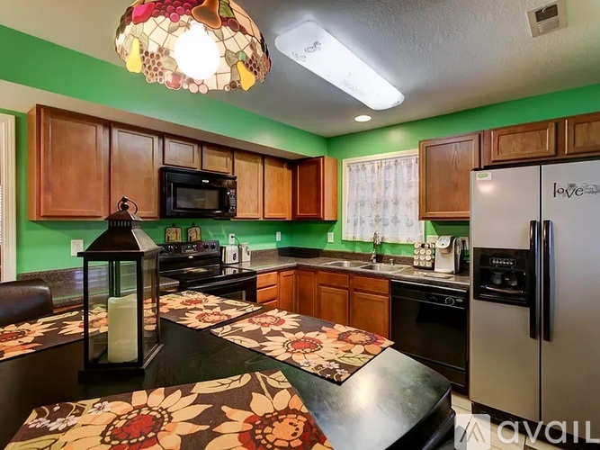 A kitchen with a table and chairs in the middle.