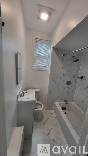A bathroom with a marble shower and toilet.