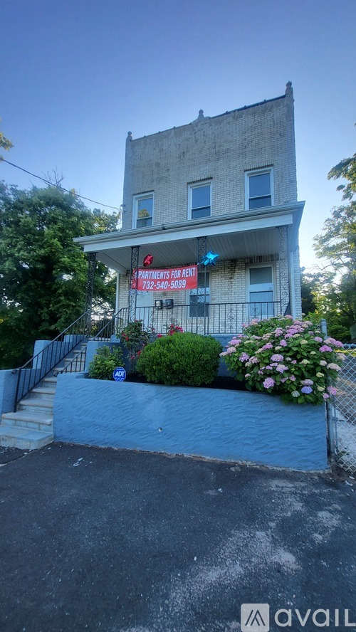 A house with a for sale sign in front of it.