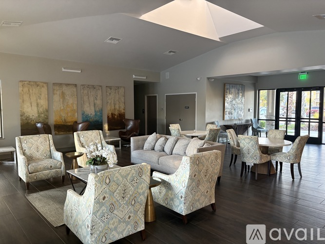 A living room with a couch, chairs, and a coffee table.