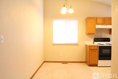 A kitchen area with wooden cabinets and a white oven.