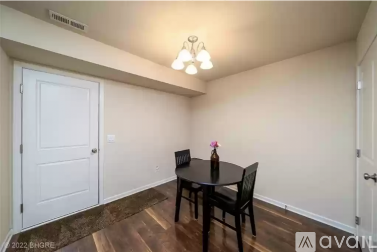A dining room with a table and chairs.