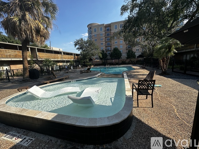 A pool with a waterfall feature in the middle of it.