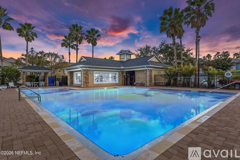 A house with a pool in front of it.