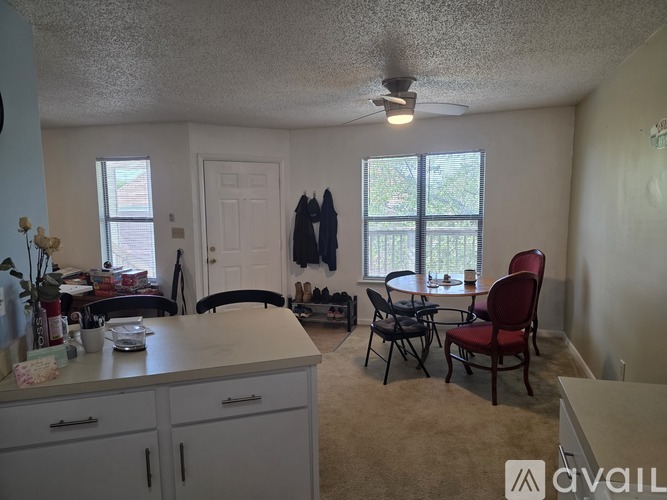 A kitchen with a table and chairs in front of a window.