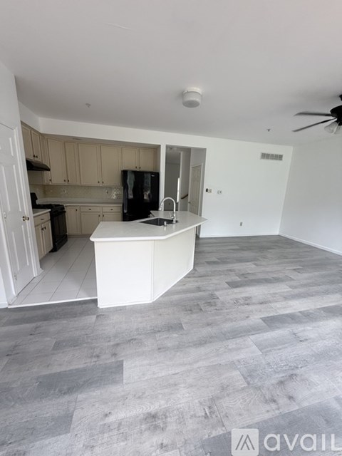 A kitchen with a white island in the middle of the room.