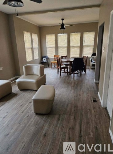 A living room with a dining table and chairs.