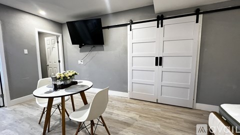 A modern dining room with a round table and chairs.