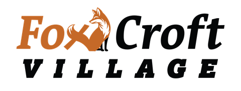 A logo with a fox and the words "Fox Croft Village" in orange and black.