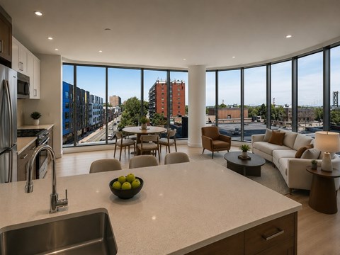 A modern kitchen with a bowl of fruit on the counter.