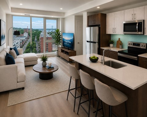 A modern kitchen with a bar stool and a TV.