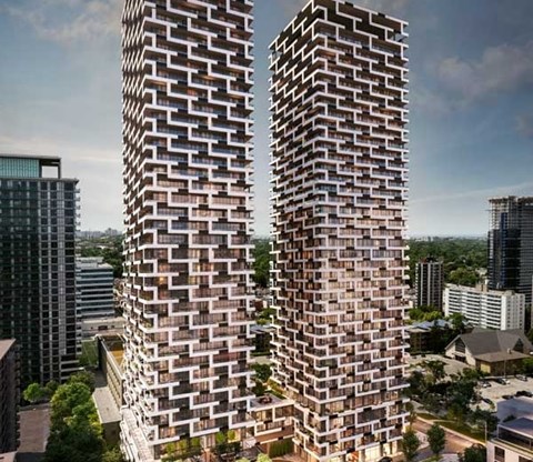 Two tall buildings with a brick facade stand side by side.