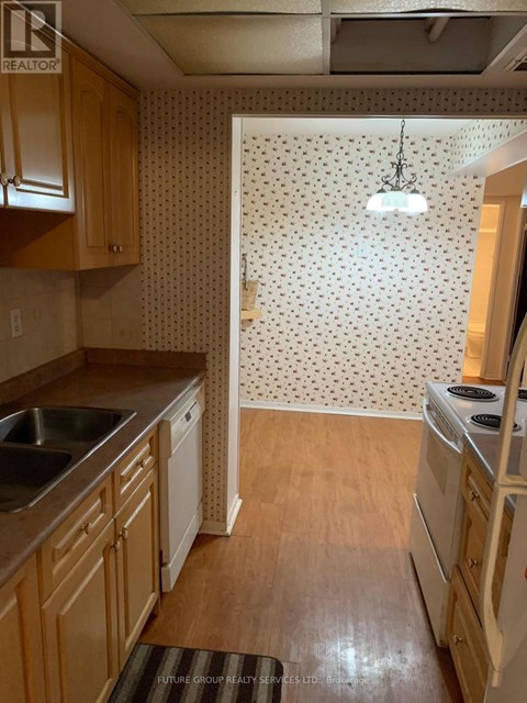 A kitchen with wooden cabinets and a white fridge.