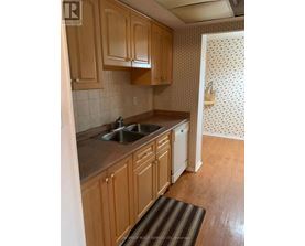 A kitchen with wooden cabinets and a sink.
