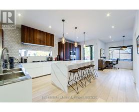 A modern kitchen with wooden cabinets and a white countertop.