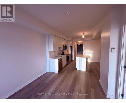 A spacious room with wooden floors and white walls.