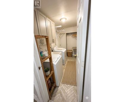 A bathroom with a white toilet and a white sink.