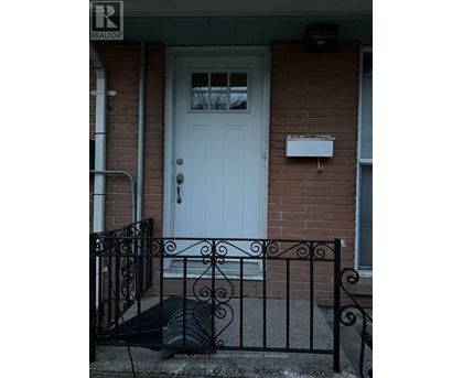 A white door with a mailbox on a brick house.