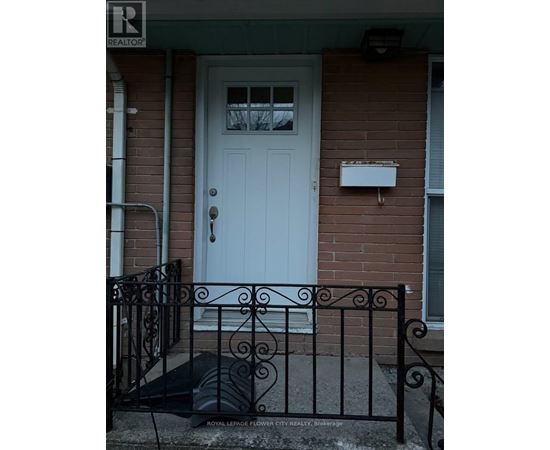 A white door with a mailbox on a brick house.