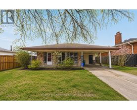 A house with a brown roof and a tree in front of it.