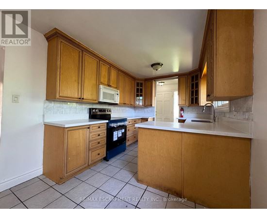 A kitchen with wooden cabinets and a white countertop.