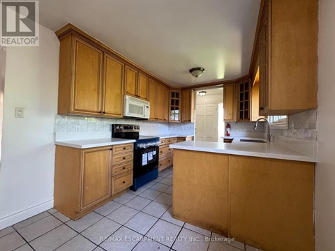 A kitchen with wooden cabinets and a white countertop.
