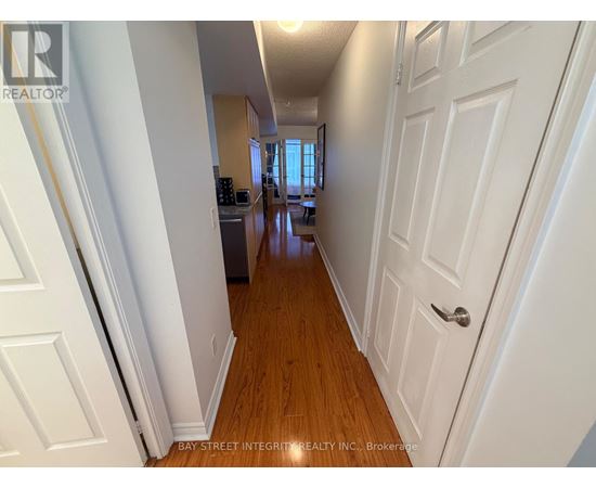 A hallway with white doors and wooden floors.