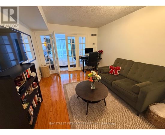 A living room with a green couch and a coffee table.