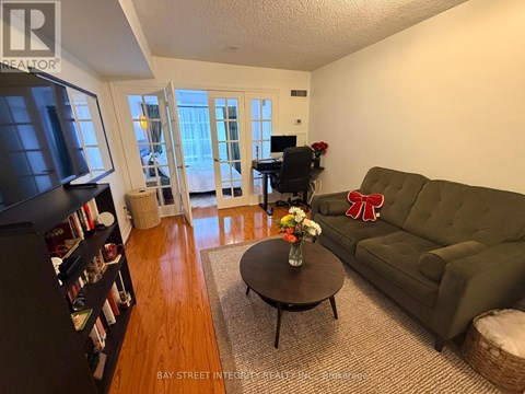 A living room with a green couch and a coffee table.