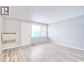 A room with a window and a door is available for rent.