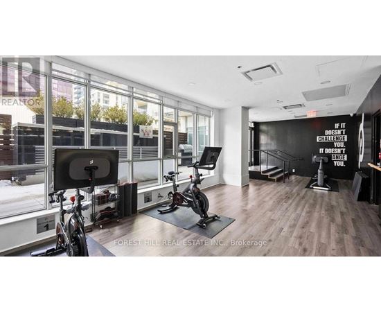 A gym room with a sign that says "If it doesn't challenge you, it doesn't improve you."