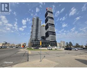 A tall building with a red roof is under construction.