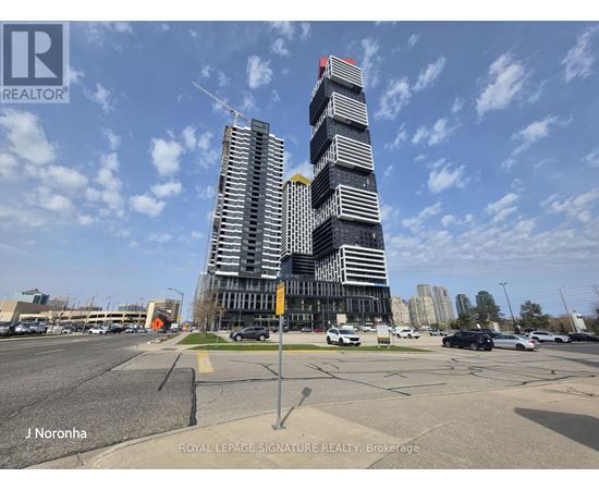A tall building with a red roof is under construction.