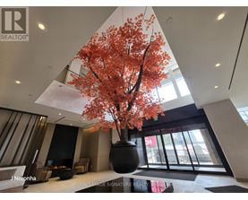 A large vase with a tree in it is in the middle of a room.