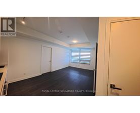 A room with a white door and a window with blinds.