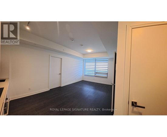 A room with a white door and a window with blinds.