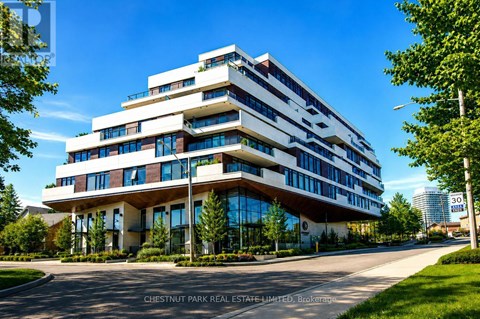 A modern multi-story building with a curved design and large windows.