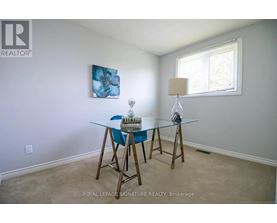 A dining room with a glass table and chairs.