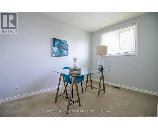 A dining room with a glass table and chairs.