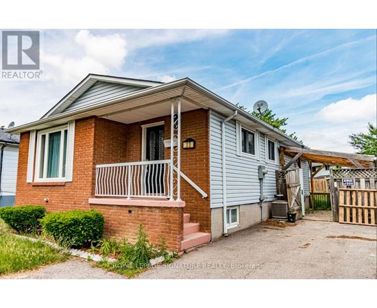A house with a red brick exterior and a white door is for sale.