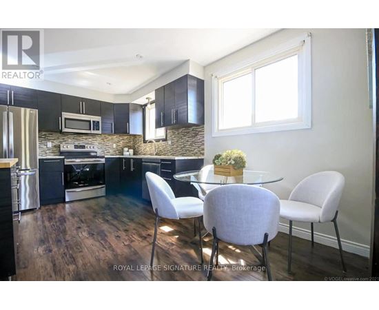 A modern kitchen with a dining table set for four.