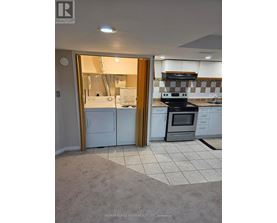 A kitchen with a white fridge and black stove.