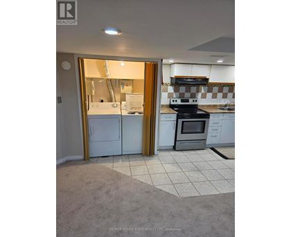A kitchen with a white fridge and black stove.