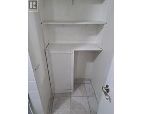 A white refrigerator with a door open in a small room.