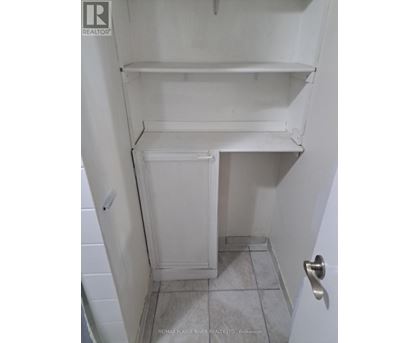 A white refrigerator with a door open in a small room.