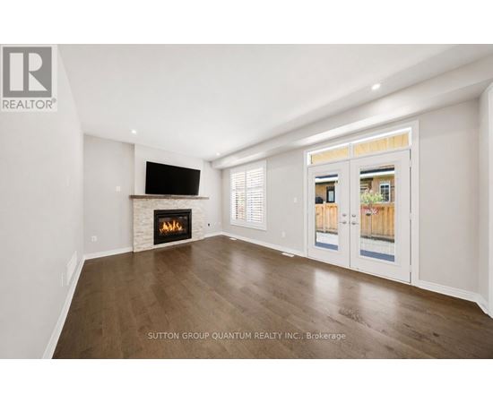 A spacious living room with a fireplace and a television.